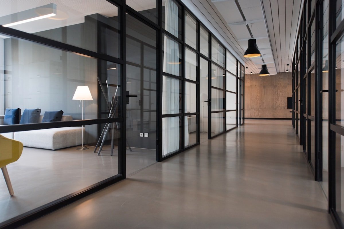 Polished floor and glass partitions in a commercial office corridor